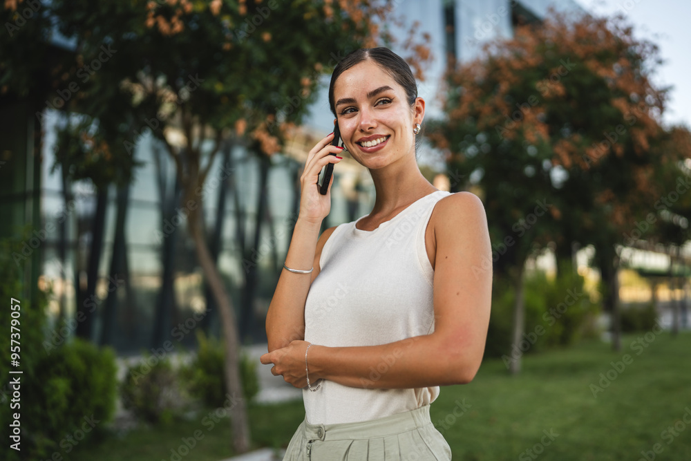 Portrait of young woman talk on mobile phone in front company outdoor Portrait of young woman talk on mobile phone in front company outdoor