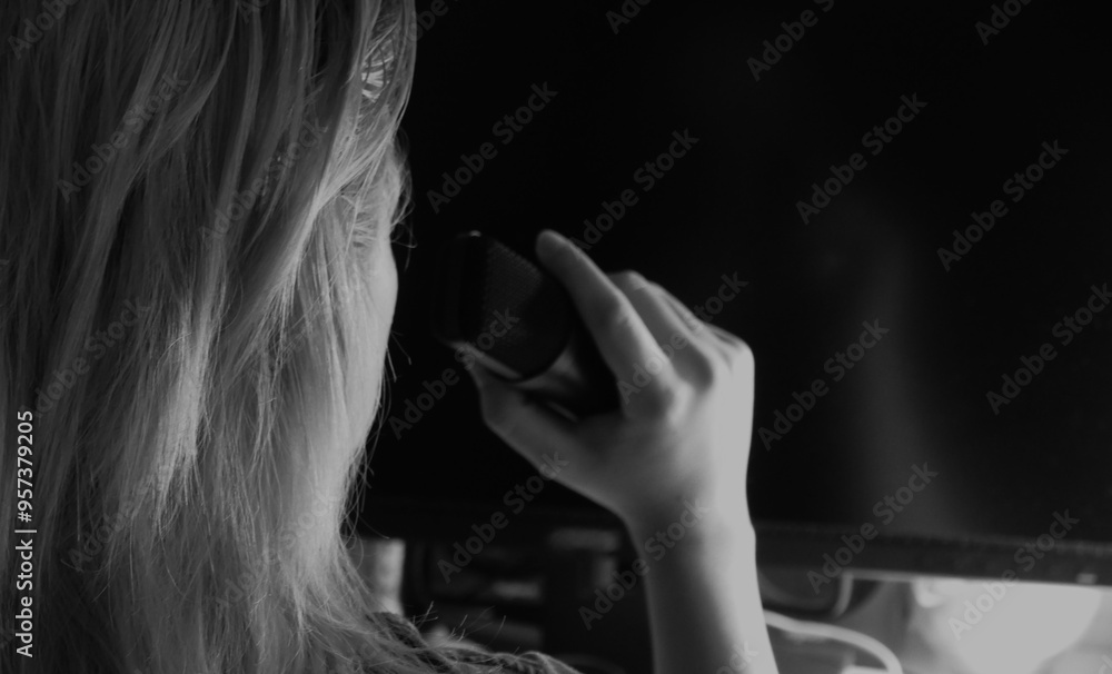 Fototapeta premium Woman speak in the microphone in studio black and white