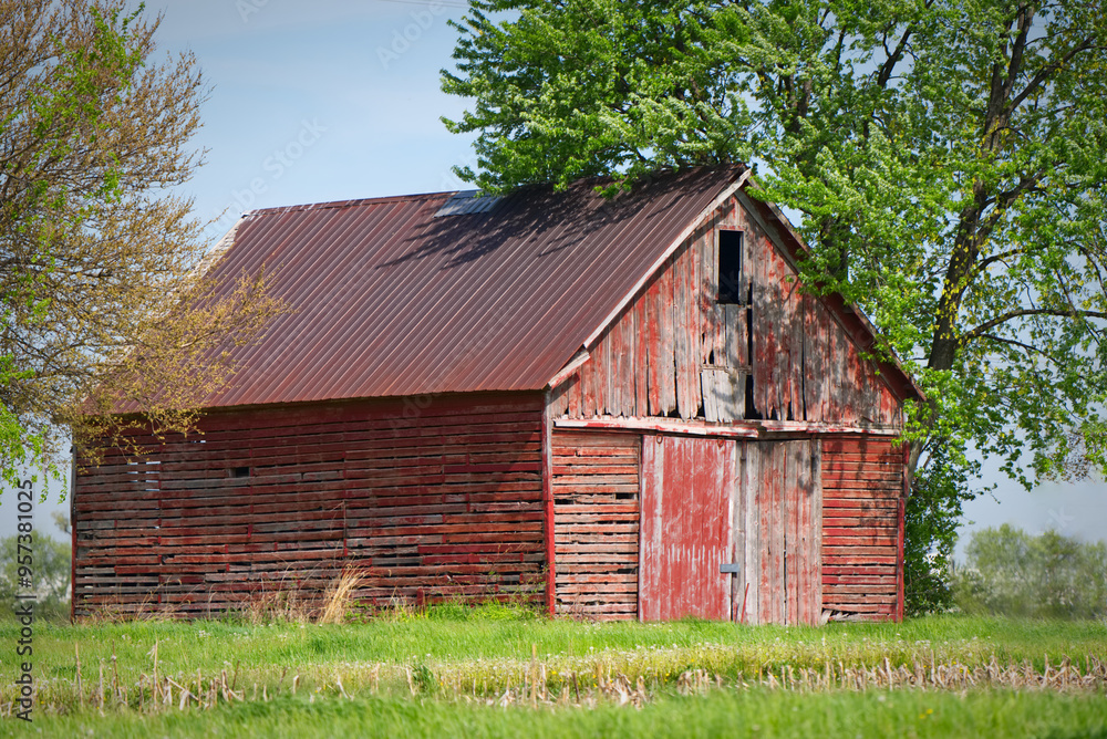 Fototapeta premium Red, dilapidated, old, weathered barn on a farm