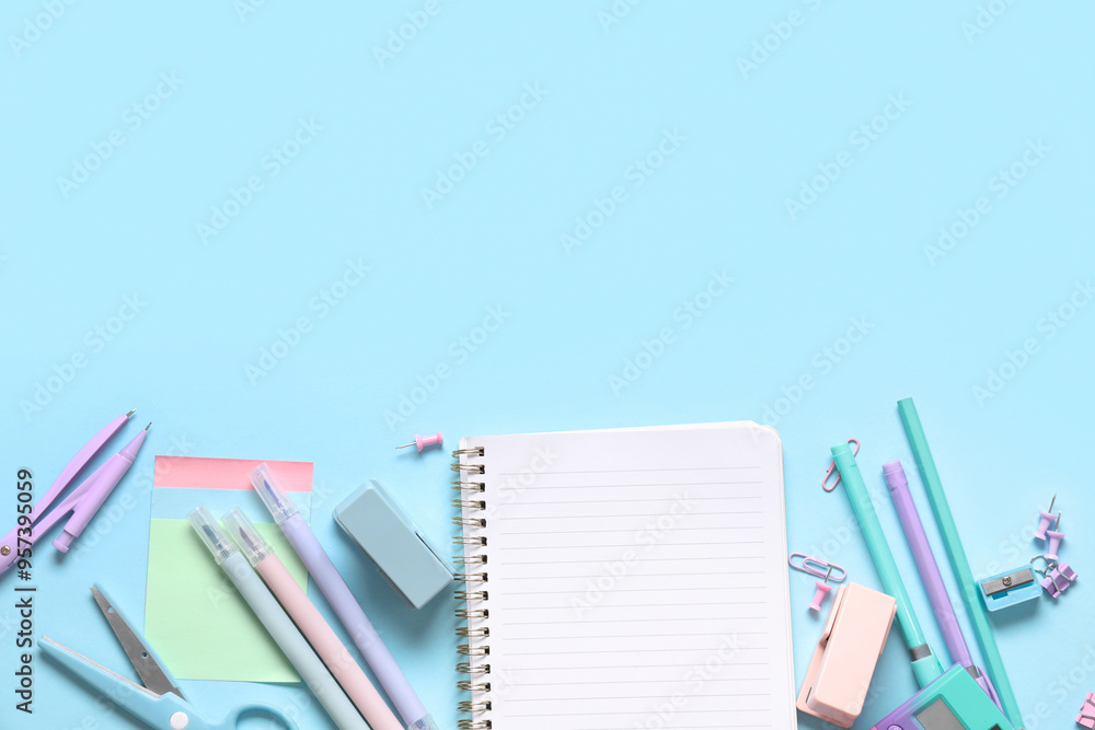 Blank notebook with different stationery supplies on blue background Blank notebook with different stationery supplies on blue background
