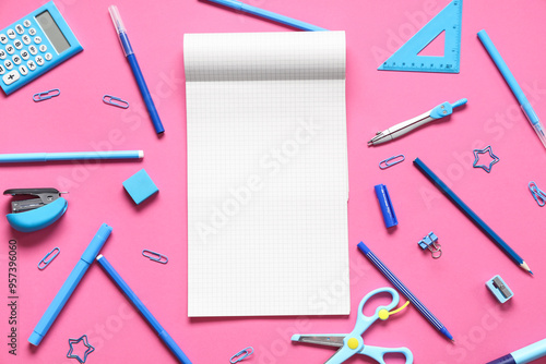 Blank notebook with different stationery supplies on pink background