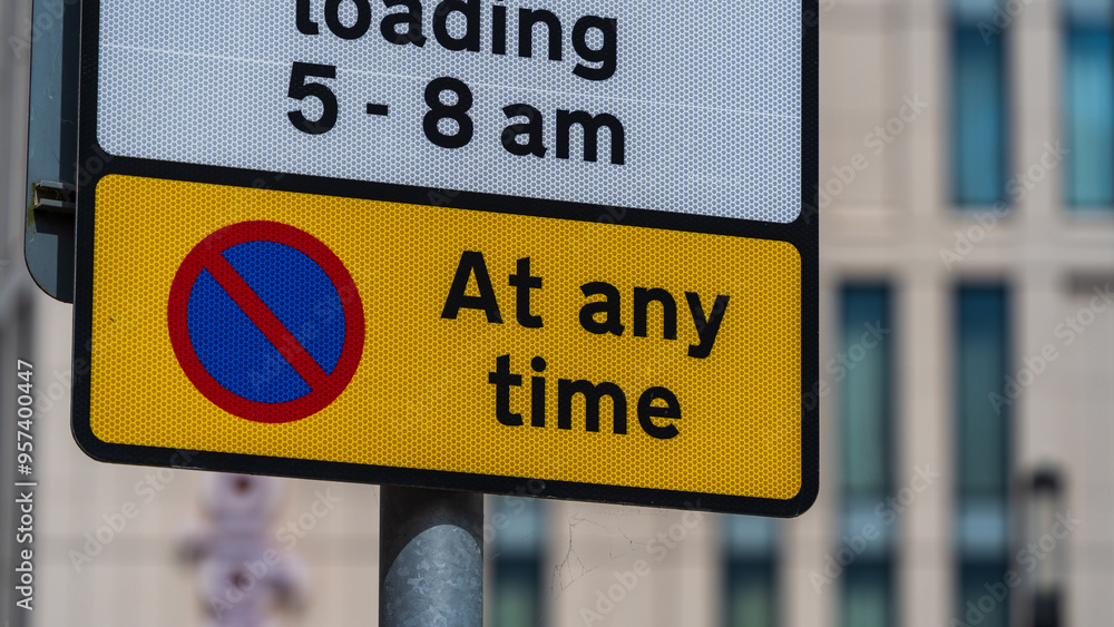 No Parking Sign with Time Restriction on a Yellow Background No Parking Sign with Time Restriction on a Yellow Background
