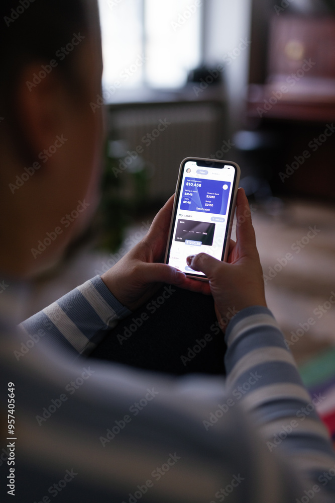 Anonymous woman checking credit card balance using bank app on phone Anonymous woman checking credit card balance using bank app on phone