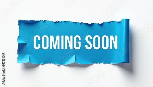 Torn blue paper with 'Coming Soon' text in white on a white background, indicating a forthcoming event or announcement. photo