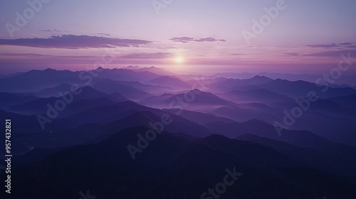   A stunning photo of a mountain range bathed in sunlight during midday, with the sun peeking over the peaks in the background