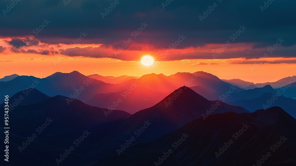 Fototapeta premium Sunset on mountain range with foreground mountains & cloudy background