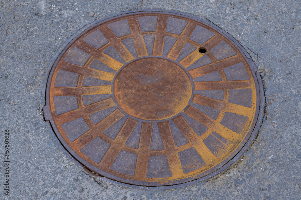 Rusty cast iron manhole cover close-up. Rusty cast iron manhole cover close-up.