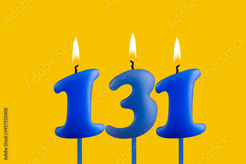 Blue candle number 131 - Birthday on yellow background