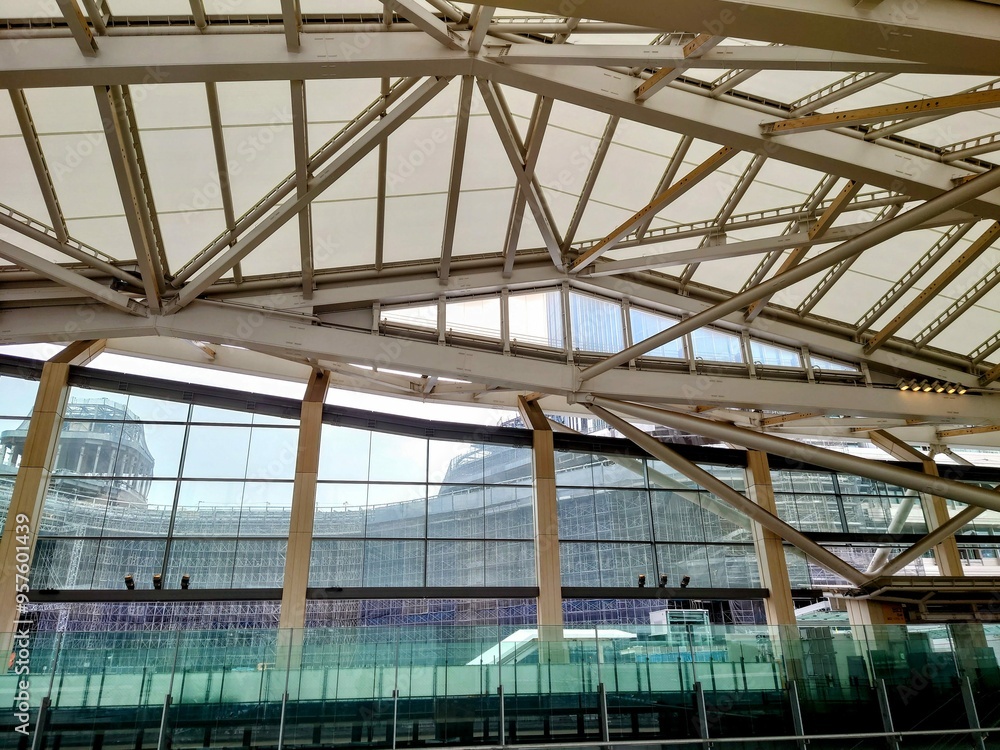 Modern architectural structure with glass and steel framework viewed from indoor transit station Modern architectural structure with glass and steel framework viewed from indoor transit station