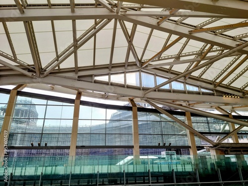 Modern architectural structure with glass and steel framework viewed from indoor transit station