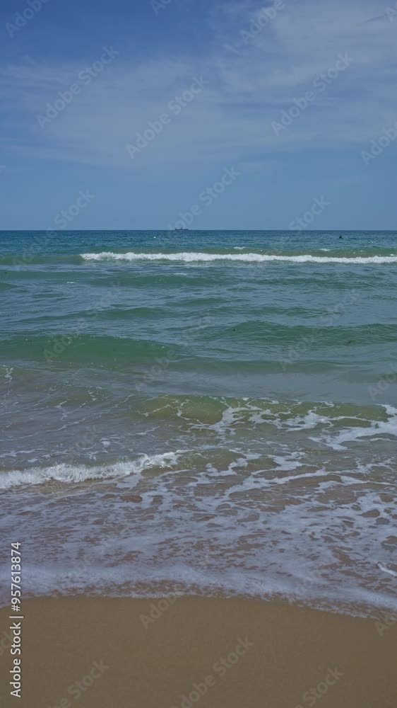 A serene beach with gentle waves, sandy shore, and blue sky under a sunny day A serene beach with gentle waves, sandy shore, and blue sky under a sunny day