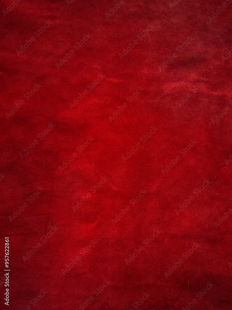 Dark red matte background of suede fabric, closeup. Vertical red velvet background, leather. Dark red matte background of suede fabric, closeup. Vertical red velvet background, leather.