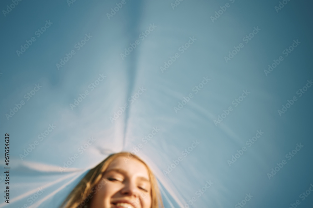 © Serge Filimonov/Stocksy - Smiling woman under blue sky - Carefree