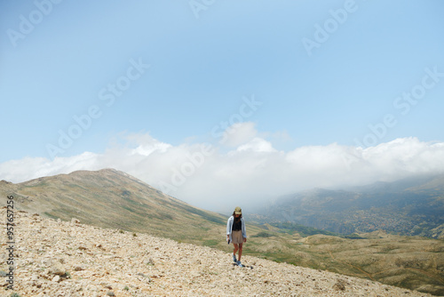 Woman Walking On Mountain Trail In Deserted Area photo