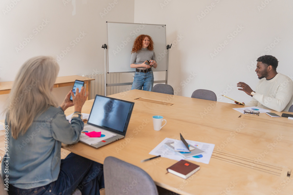 Woman Presenting To Team In Office. Woman Presenting To Team In Office.