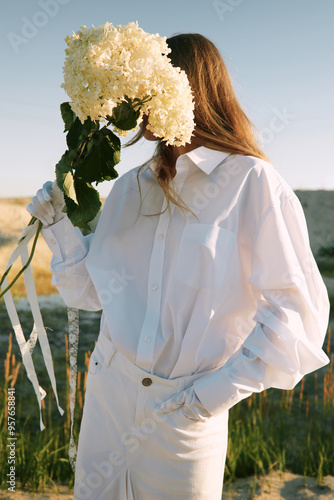 Wedding fashion - Woman in White Outfit Hold Flower 