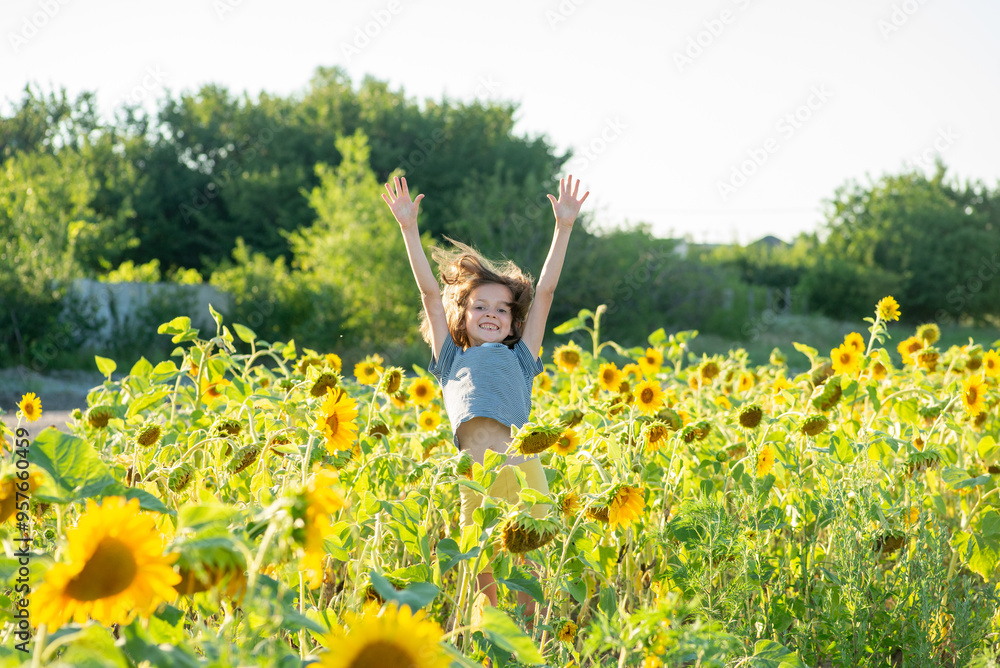 Happy child jumping in a field with sunflowers Happy child jumping in a field with sunflowers