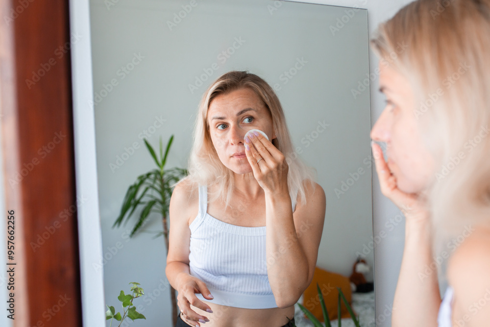 blondy woman applying serum, cream to face blondy woman applying serum, cream to face
