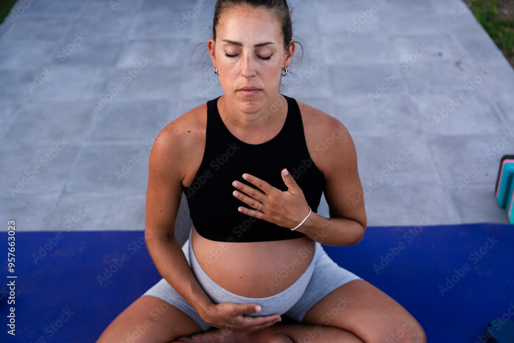 Pregnant woman practicing prenatal yoga Pregnant woman practicing prenatal yoga