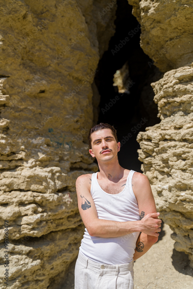 model posing in desert canyon wearing white tank top model posing in desert canyon wearing white tank top