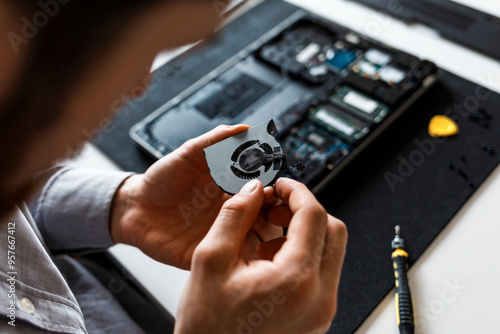 Man repairing a laptop computer photo