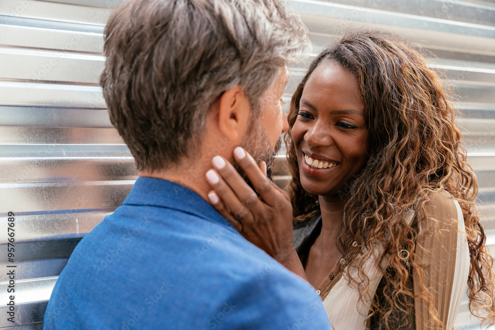 Intimate moment between a diverse couple in urban setting Intimate moment between a diverse couple in urban setting