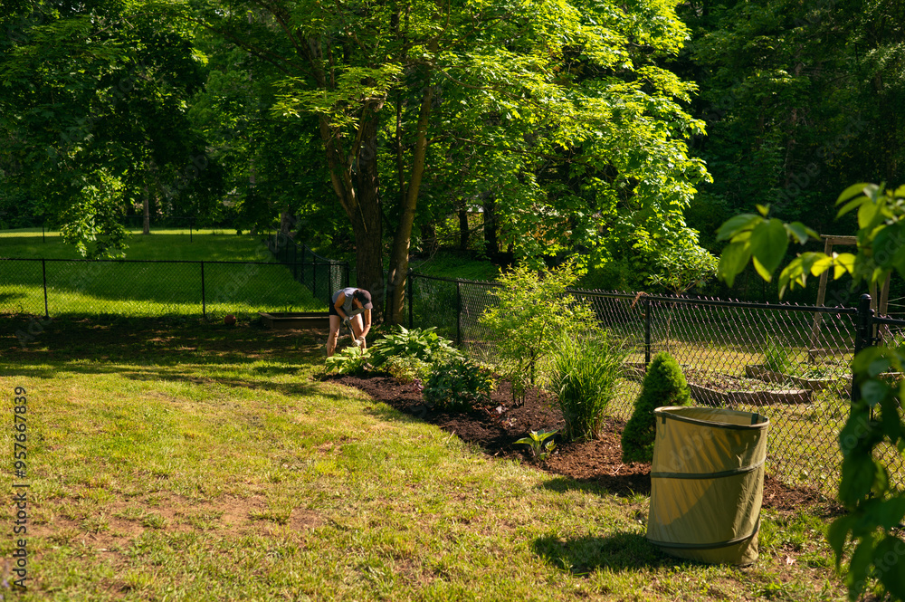 woman gardening on sunny day in her backyard