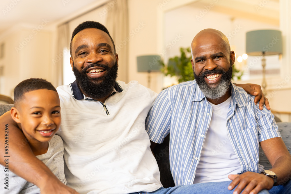 Smiling family of three generations sitting together on couch at home Smiling family of three generations sitting together on couch at home