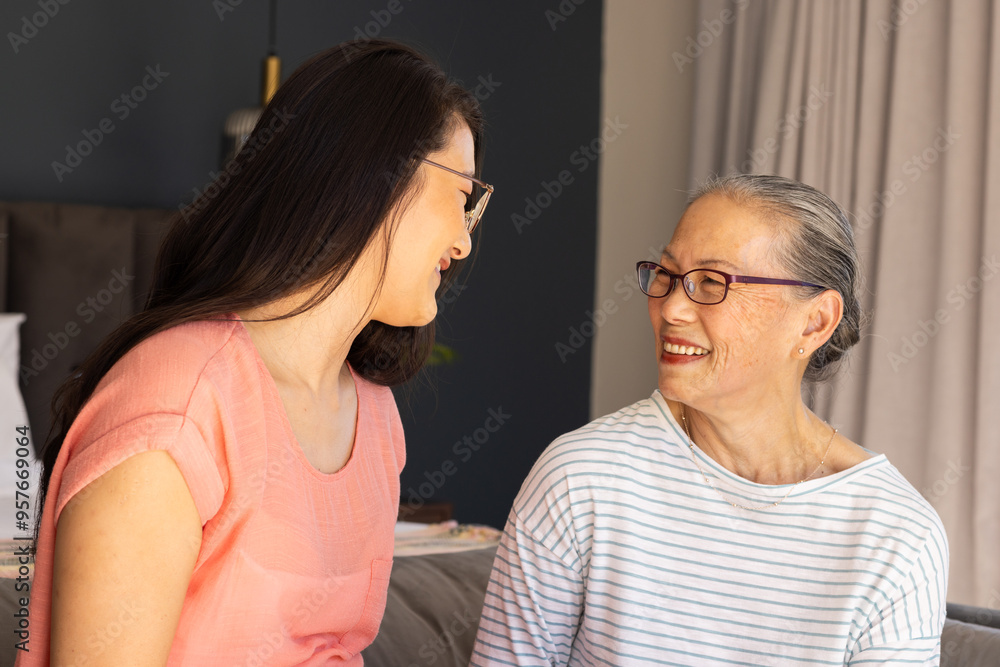 Smiling asian grandmother and granddaughter, mother and daughter bonding and enjoying quality time t Smiling asian grandmother and granddaughter, mother and daughter bonding and enjoying quality time t