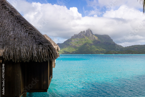 Overwater bungalow on tropical island Bora Bora. The azure lagoon is a bucket list destination for vacation travel.  photo