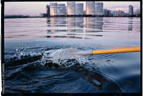 splash from an oar in a city lake photo