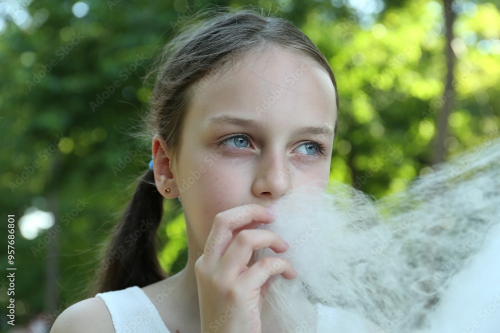 Little girl eating sweet cotton candy in park Little girl eating sweet cotton candy in park