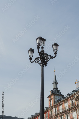 A tall, ornate black street lamp with multiple lanterns photo