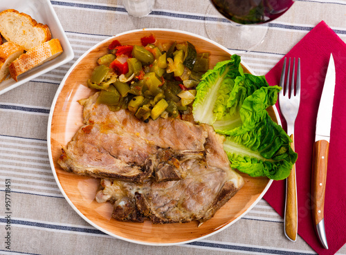 Delicious roasted pork chop served with stewed vegetables