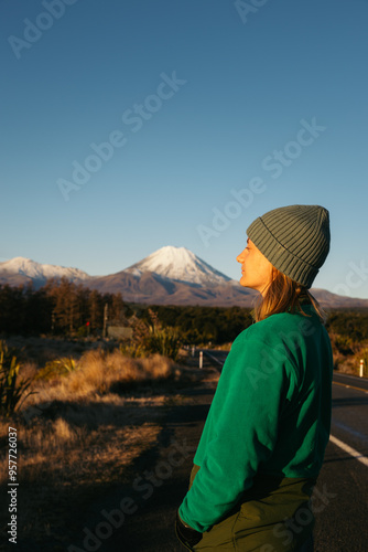 Woman watching the Mount Ngauruhoe from the road photo