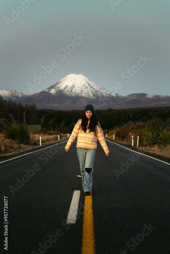 Woman on a road with views of snow-covered Mount Ngauruhoe photo