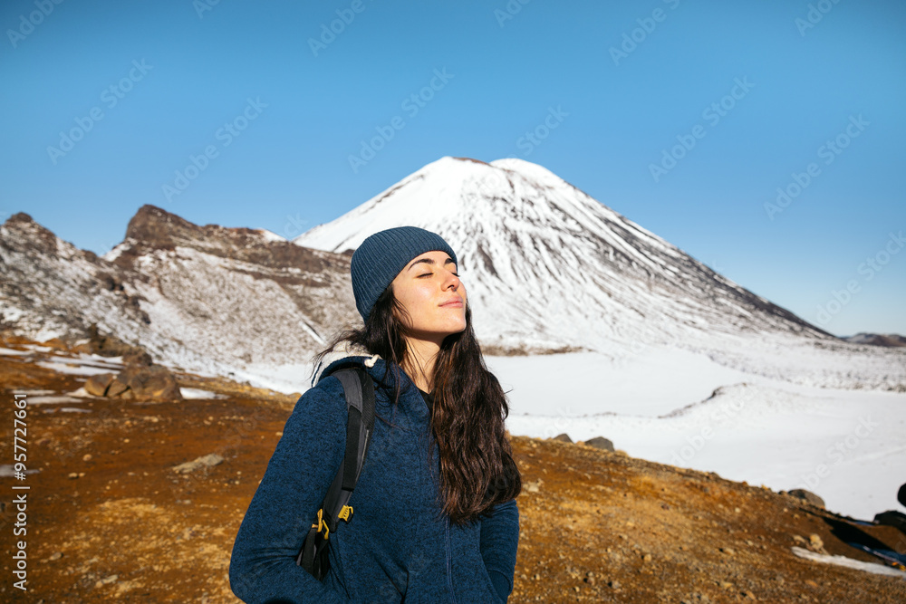 Woman visiting Mount Ngauruhoe in a winter sunny day Woman visiting Mount Ngauruhoe in a winter sunny day