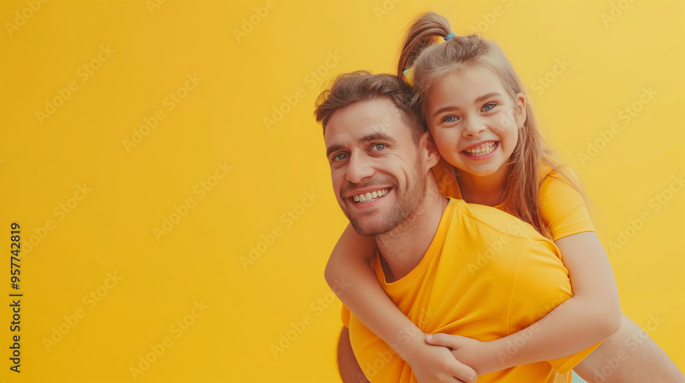 Cute little girl sitting on father's shoulders on blue background Cute little girl sitting on father's shoulders on blue background