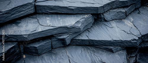 A close-up view of dark slate stone layers, showcasing natural textures and geological patterns, ideal for backgrounds and designs. photo