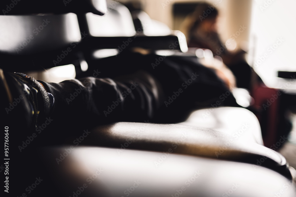 Selective focus on the feet of a child asleep on a row of chairs in an airplane terminal Selective focus on the feet of a child asleep on a row of chairs in an airplane terminal