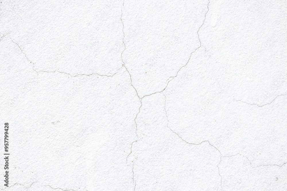 Obraz premium Cracked plaster on an old concrete wall. White wall texture background with thin shabby cracks.