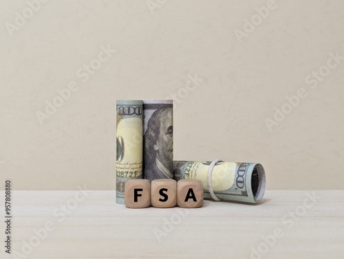 banknotes and wooden cube with FSA letters. stand for Flexible Spending Account. business concept