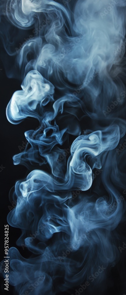 Fototapeta premium Elegant blue smoke swirling gracefully against a black background, creating mesmerizing patterns and textures.
