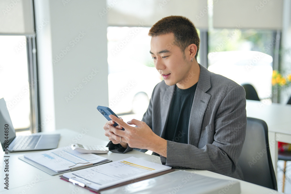 Fototapeta premium Asian Businessman with Smartphone&nbsp;working mobile devices cell telephone technology e-commerce smartphone business professional investor working new start up project