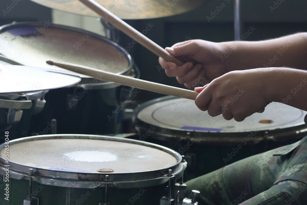 Fototapeta premium Close-up of musician playing drums on stage Selectable focus
