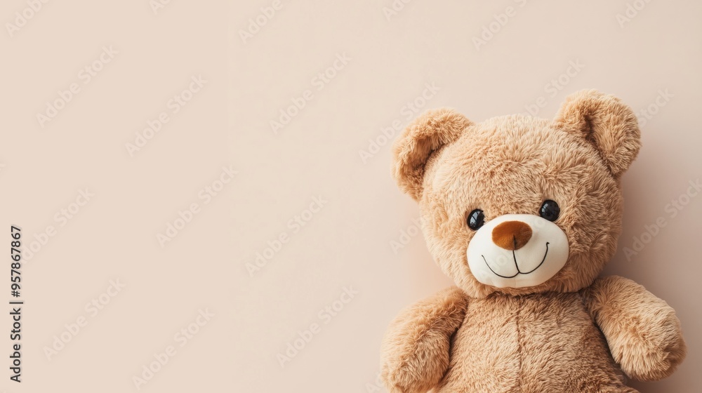 A single brown teddy bear on a light brown background A single brown teddy bear on a light brown background