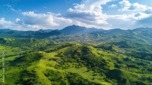 Scenic aerial view of lush hills and ravine with majestic mountain backdrop ideal for tourism and advertising Drone captured tropical scenery