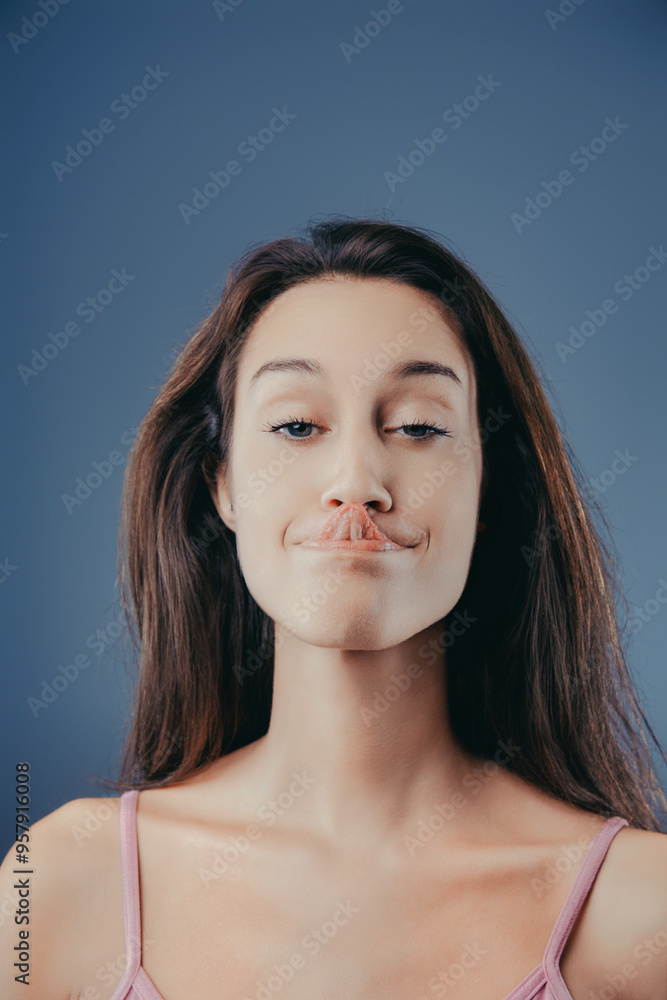 Young woman making funny face and sticking out tongue Young woman making funny face and sticking out tongue