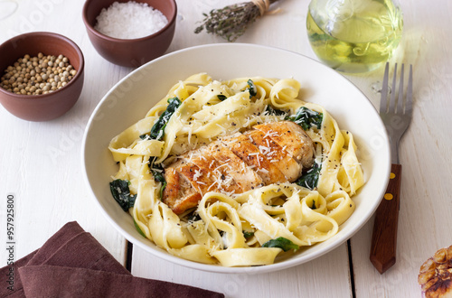 Pasta alfredo with chicken, spinach and cheese. Italian food.