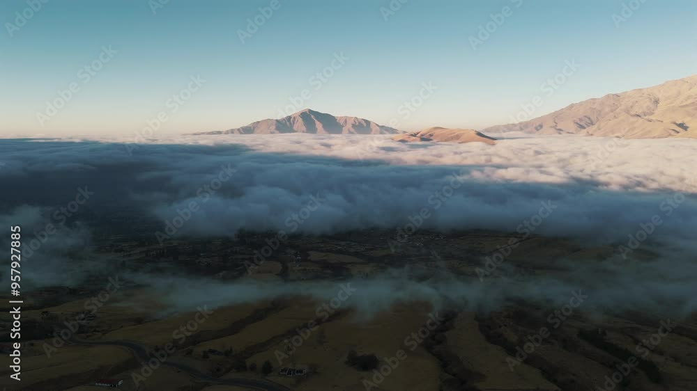 Breathtaking drone view of a sunrise above the clouds in Tafí del Valle, near the Andes Mountains in Tucumán, Argentina. Breathtaking drone view of a sunrise above the clouds in Tafí del Valle, near the Andes Mountains in Tucumán, Argentina.